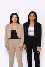 Modern cropped blazer with square shoulders and tailored sleeves. Tapered pant with a high waist and cropped petite hem. Essential bodysuit with two reversible necklines and a seamless thong